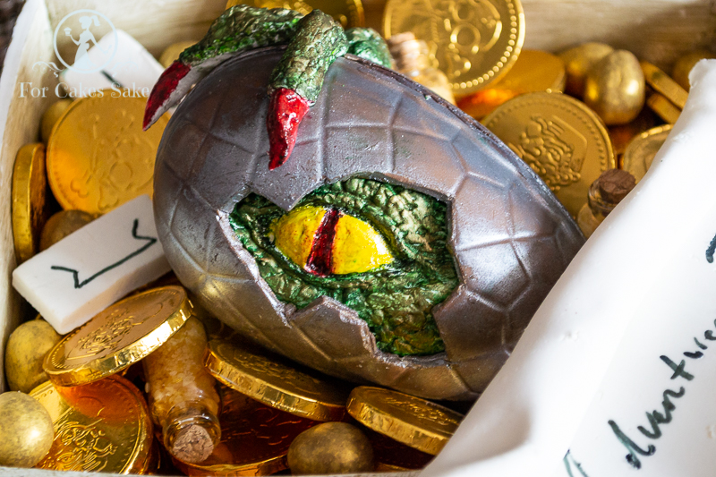 Chocolate egg with baby dragon emerging. 