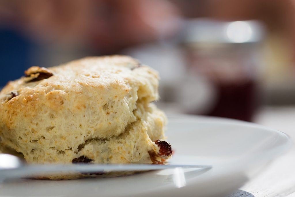 An Irish scone waiting to be enjoyed with clotted cream and jam,

